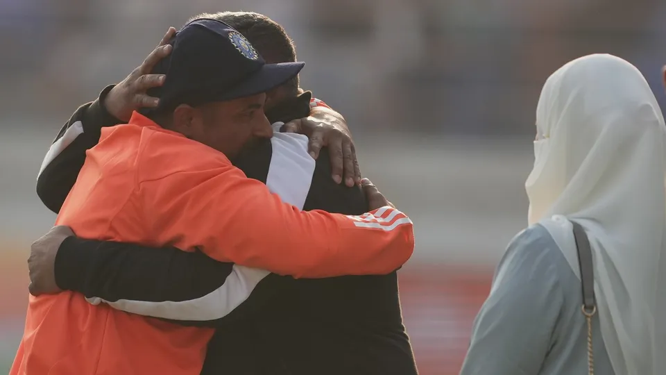 India's Sarfaraz Khan hugs his father Naushad Khan after receiving his debut Test cap during the third cricket Test match between India and England