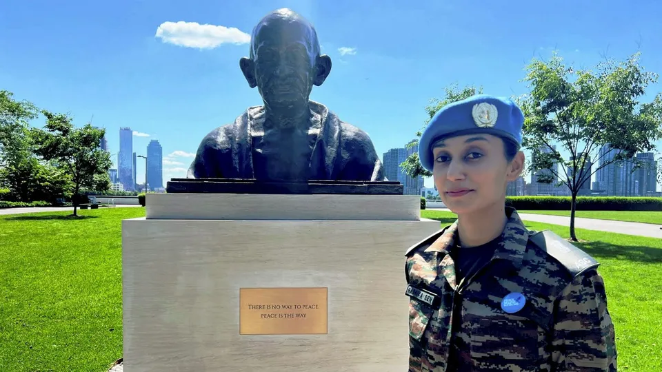 Major Radhika Sen of India stands near the Gandhi Statue at UN HQ