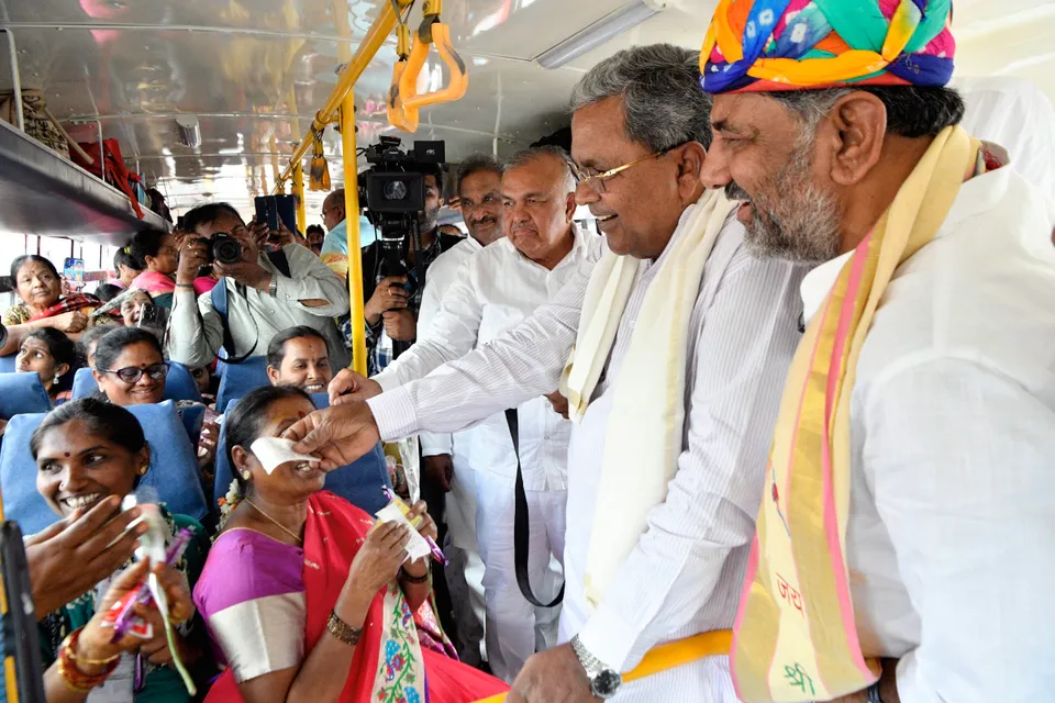 Karnataka Chief Minister Siddaramaiah with his deputy D K Shivakumar interacts with women passengers in a bus during the launch of the 'Shakti Yojane'