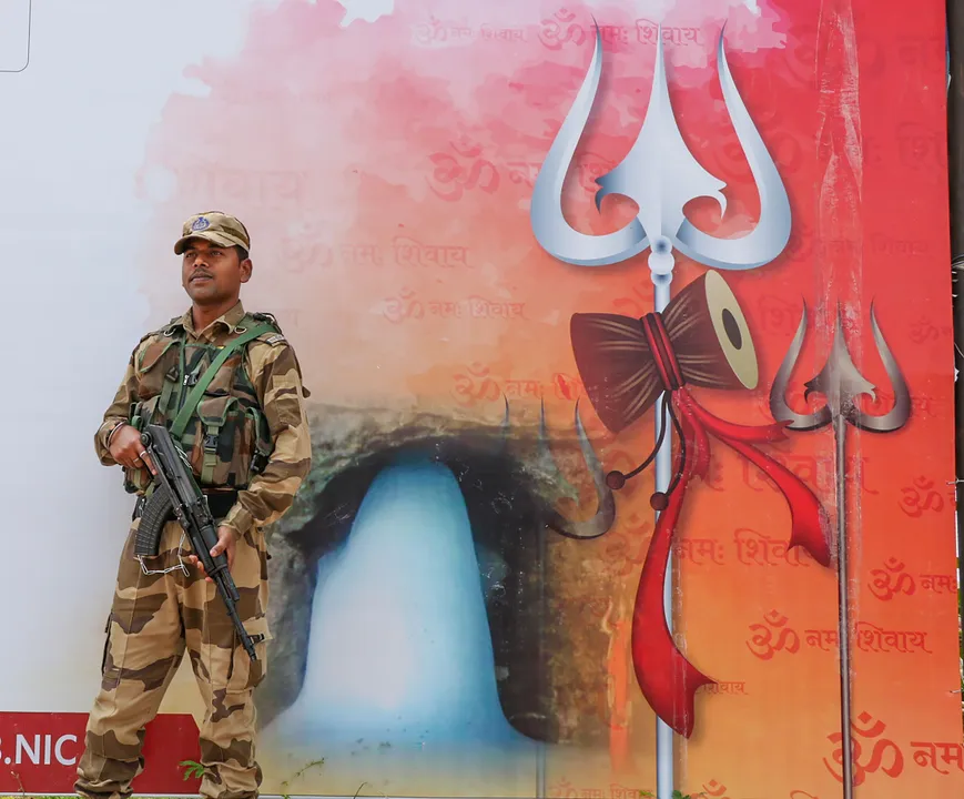 A security personnel stands guard at Yatri Niwas base camp ahead of the commencement of the Amarnath Yatra 2023, in Jammu.jpg
