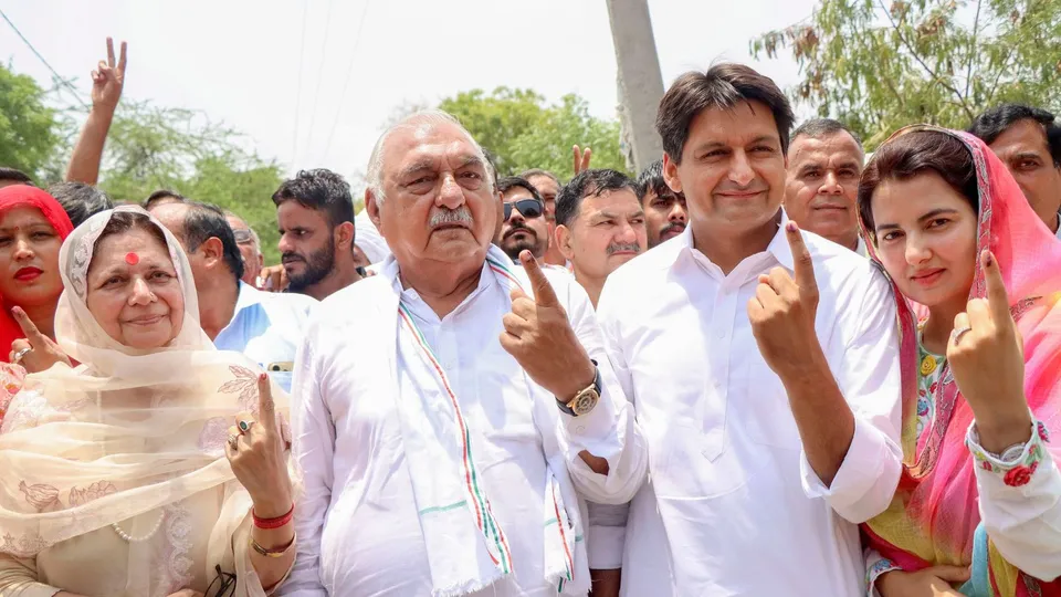 Congress leaders Bhupinder Singh Hooda and Deepender Singh Hooda after casting their votes at a polling booth during the sixth phase of Lok Sabha elections, in Rohtak, Saturday, May 25, 2024
