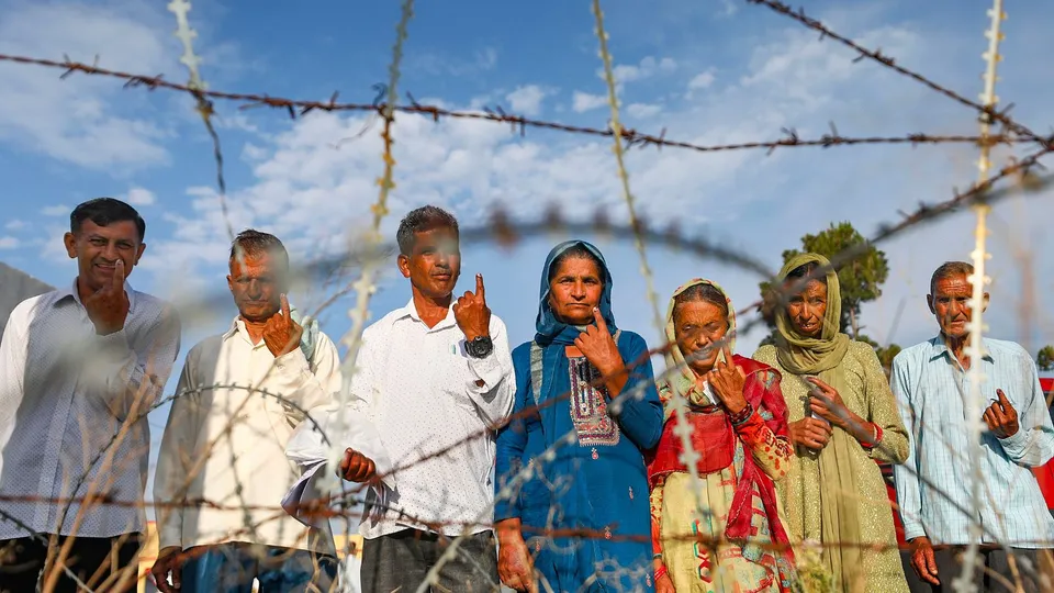 People show their inked fingers after casting their votes during the sixth phase of Lok Sabha elections, along the Line of Control (LoC) at Nowshera, in Rajouri district, Saturday, May 25, 2024