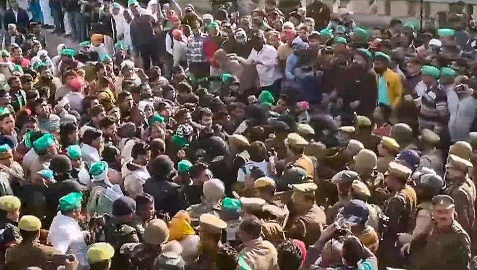 Police personnel try to stop farmers during their protest march to the national capital, in Noida