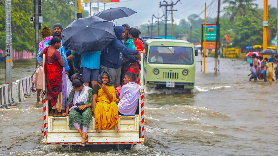 People shift to safe places from a flood-hit area following heavy rains, in Thoothukudi