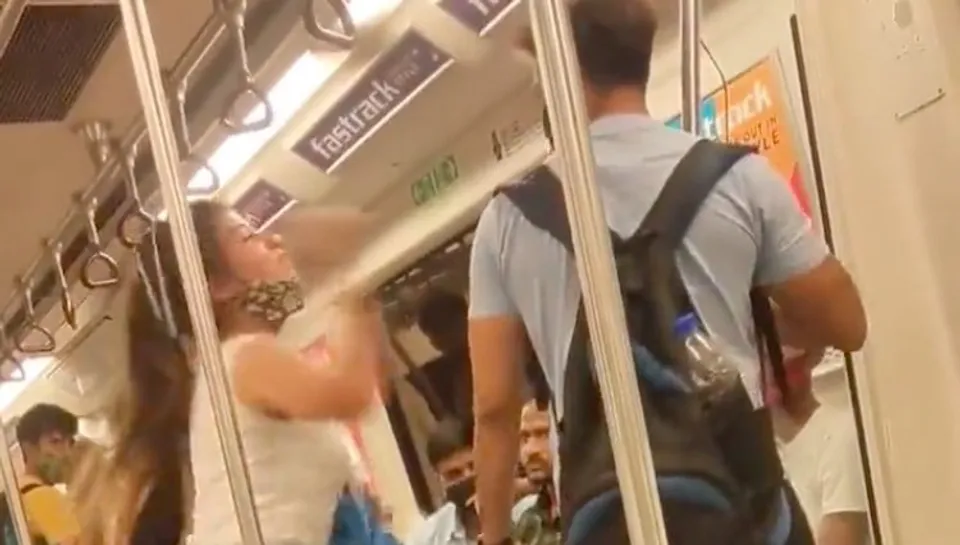 A still from the video showing woman hitting man in Delhi metro