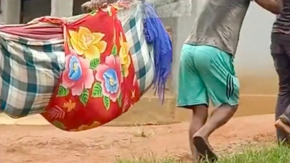 Meghalaya woman being carried on bamboo stretcher