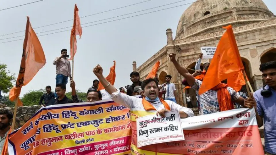 Protestors with posters and banners at Qutub Minar