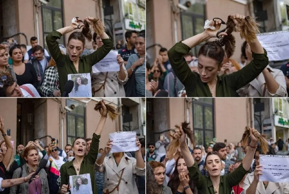 A woman cuts her hair outside Iranian embassy in Istanbul in support of Iranian women protesting  against the hijab