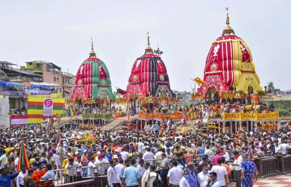 Devotees throng the chariots of Lord Jagannath, Lord Balabhadra and Goddess Subhadra during the annual Rath Yatra of Lord Jagannath, in Puri