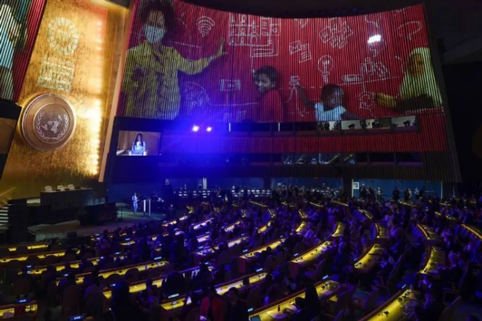 At the United Nations headquarter, journalist Folly Ba Thibaut speaks while images are projected on the wall