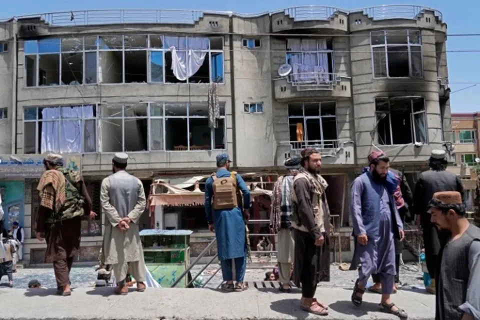Taliban fighters guard the site of the deadly attack in Kabul. Several explosions and gunfire ripped through the temple in Afghanistan's capital