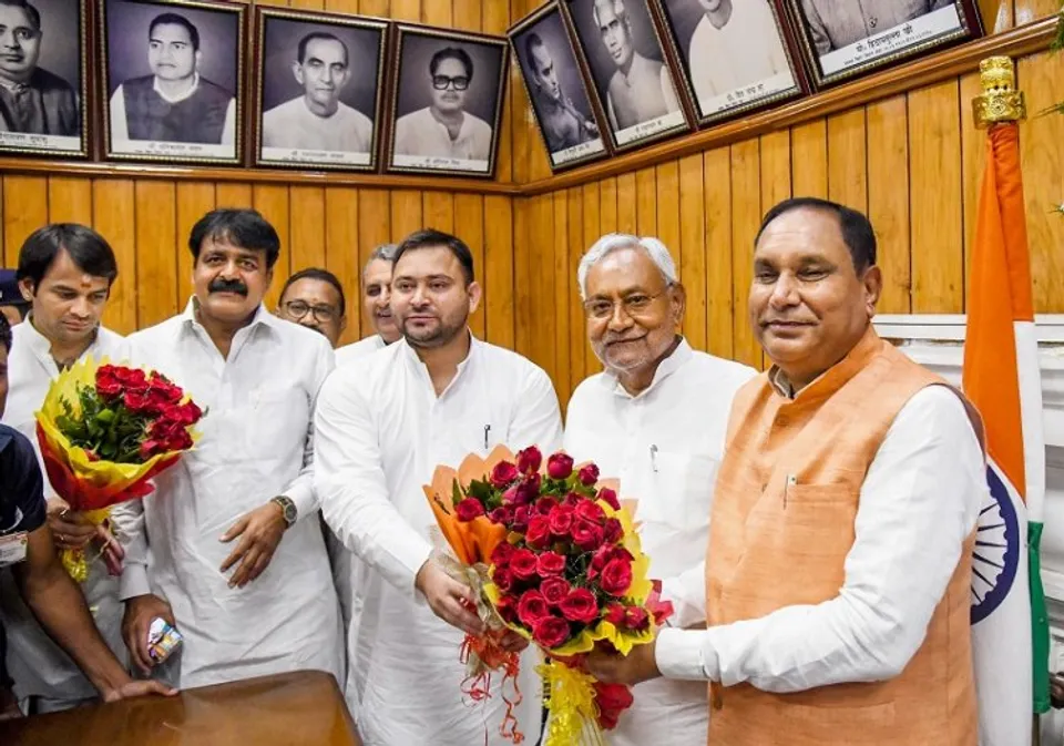 Bihar Chief Minister Nitish Kumar and Deputy CM Tejashwi Yadav greet acting Speaker Maheshwar Hazari during special session of Bihar Legislative Assembly, in Patna