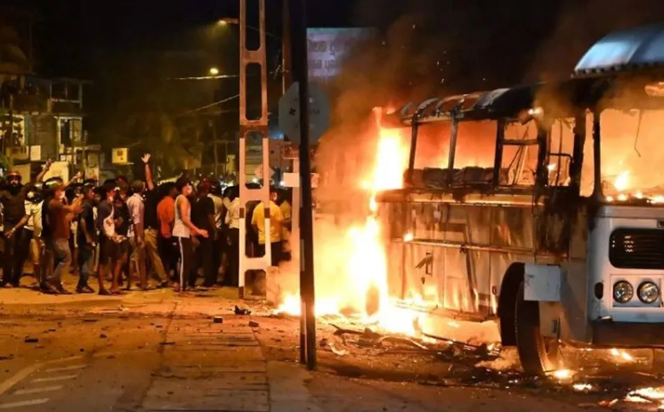 Protestors torch a bus parked nearby President's house