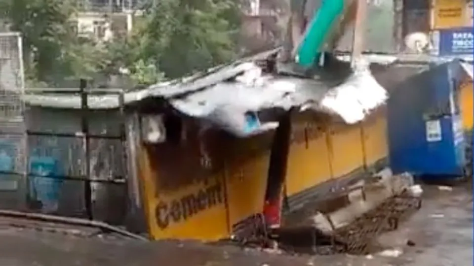 Video grab of the shops being washed away in Kullu cloudburst