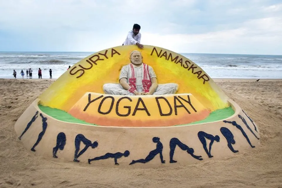 Sand artist Sudarsan Pattnaik creates a sand sculpture of Prime Minister Narendra Modi in yoga pose, on the eve of International Day of Yoga, at Puri beach