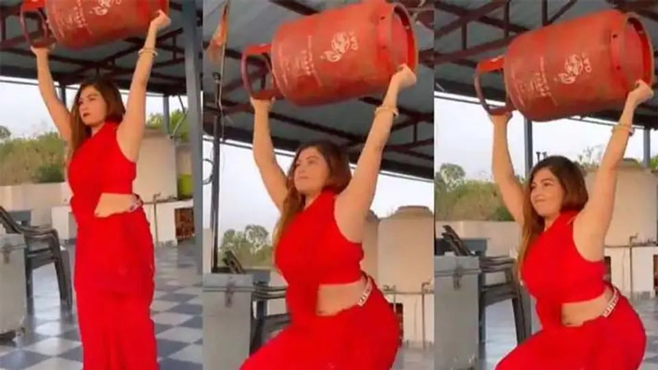 ഗ്യാസ് സിലിണ്ടർ പൊക്കി പിടിച്ച് 'സ്‌ക്വാട്ട്സ്' ചെയ്യുന്ന യുവതി